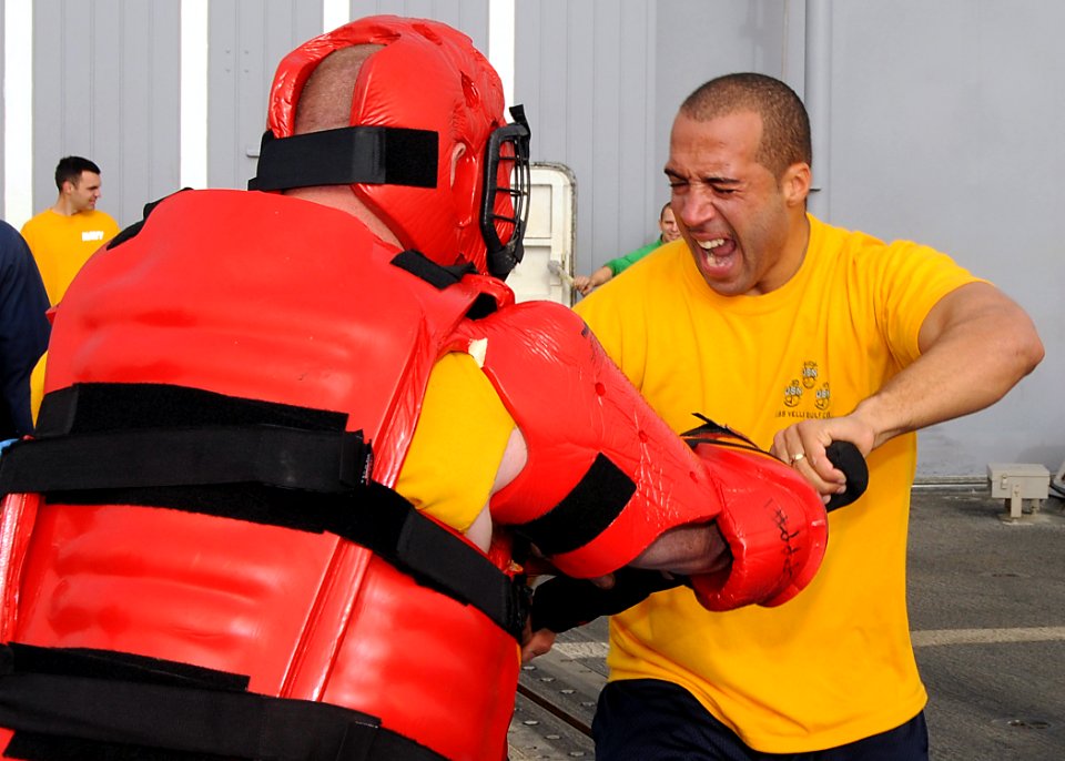 US Navy 090306-N-1082Z-042 Chief Quartermaster Matthew H. Hebert uses a baton to defend himself against Gunner's Mate 1st Class Kevin B. Miller after being sprayed with Oleoresin Capsicum (OC)