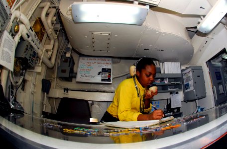 US Navy 090306-N-0096C-127 Aviation Boatswain's Mate (Handling) Airman Alicia Lucas, from Mobile, Ala., logs aircraft movements in hangar deck control aboard the Nimitz-class aircraft carrier USS John C. Stennis (CVN 74)