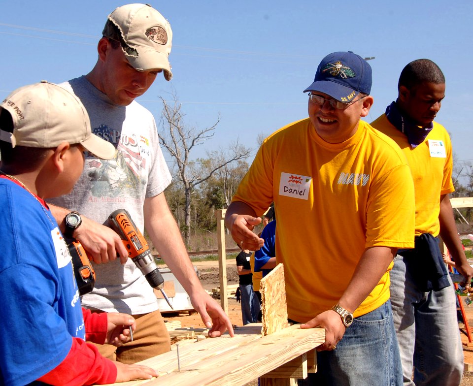 US Navy 090307-N-8816D-308 Seabees help local volunteers construct a 4,300 square foot playground at Pass Christian Elementary School in Pass Christian, Miss