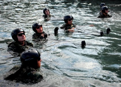 US Navy 090305-N-5366K-015 Special Warfare Combatant-craft Crewmen candidates check the integrity of their floatation devices photo
