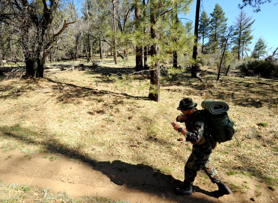 US Navy 090317-N-2959L-895 Basic Underwater Demolition-SEAL (BUDs) candidate Seaman Jared Hougtalen checks his map as he walks to find his next checkpoint during an individual basic land navigation exercise