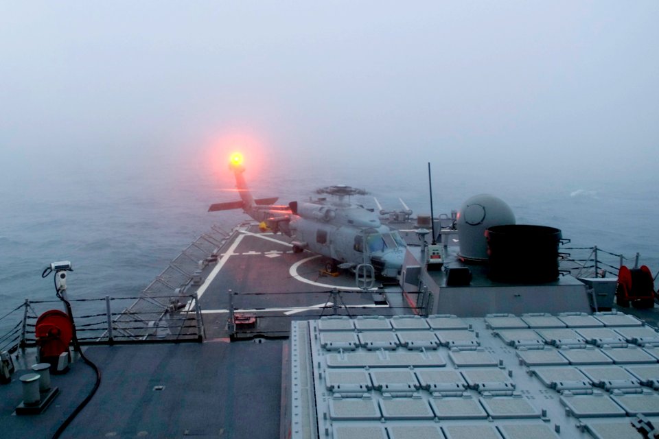 US Navy 090317-N-9123L-002 n SH-60B helicopter stands by on the flight deck of the guided-missile destroyer USS John S. McCain (DDG 56) after making an emergency landing due to poor visibility