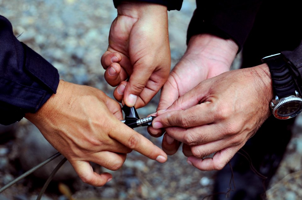US Navy 090306-N-7130B-308 Armed Forces of the Philippines soldiers attach blasting caps to detonation cord before conducting a controlled demolition of live ordnance near Zamboanga City, Philippines