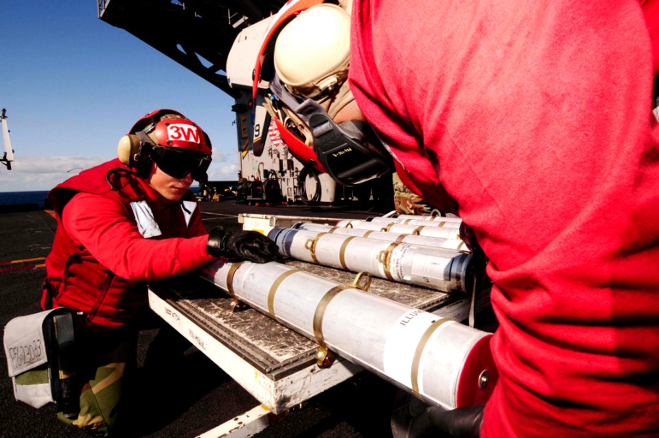 US Navy 090306-N-9760Z-005 Aviation Ordnanceman 3rd Class Michael Mayer assembles a parachute flare on the flight deck of the nuclear-powered aircraft carrier USS Nimitz (CVN 68)