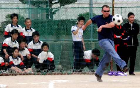 US Navy 090318-N-0807W-341 Students from Hiu Junior High School in Sasebo watch as Sailors from Fleet Activities Sasebo play a game of kick ball during a community service project photo