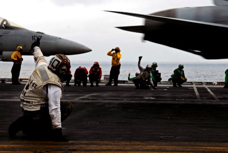 US Navy 090307-N-9928E-108 Aviation Machinist's Mate 2nd Class Rudy Batanpaning, left, from Pampanga, Philippines, gives a
