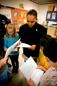 US Navy 090319-N-2953W-002 Yeoman 2nd Class Victoria Scott, assigned to Navy Cyber Defense Operations Command, reads to Bayside Elementary School students