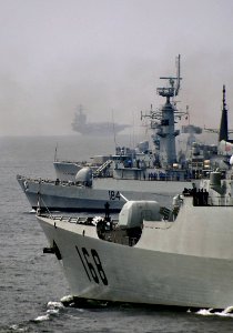 US Navy 090311-N-4774B-044 The aircraft Carrier USS Theodore Roosevelt (CVN 71), background, joins a multinational battle group formation