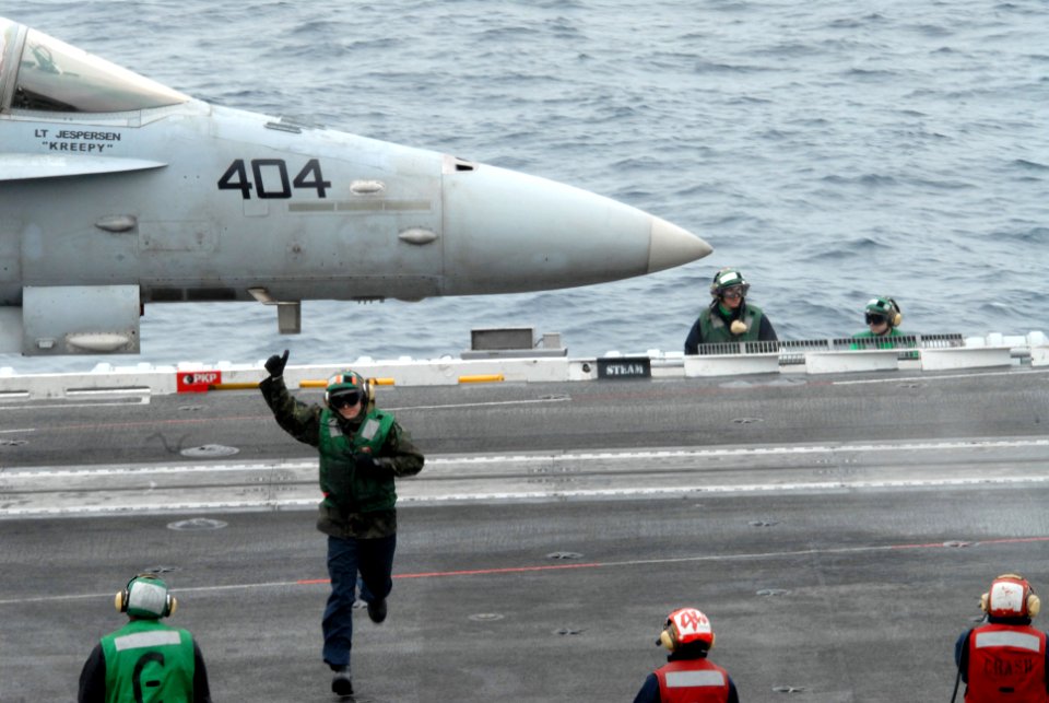 US Navy 090316-N-2344B-092 Aviation Boatswain's Mate (Equipment) 3rd Class Cameron Owens gets to his position after completing launch bar checks on an F-A-18C Hornet