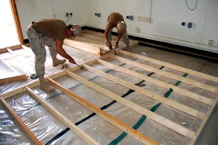 US Navy 090317-N-1057H-105 Seabees assigned to Naval Mobile Construction Battalion (NMCB) 11 Detachment. Horn of Africa install a new floor