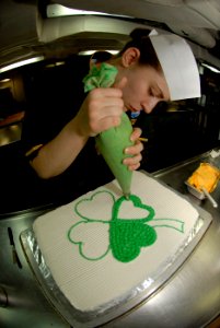 US Navy 090317-N-2475A-043 Culinary Specialist 3rd Class Rechele Rosposa, from Bremerton, Wash., decorates a Saint Patrick's Day cake in the ship's bake shop aboard the aircraft carrier USS John C. Stennis (CVN 74)