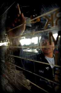 US Navy 090317-N-7280V-043 Operations Specialist 3rd Class Glenn Mupas updates the status board while standing watch on the bridge aboard USS Blue Ridge (LCC 19)