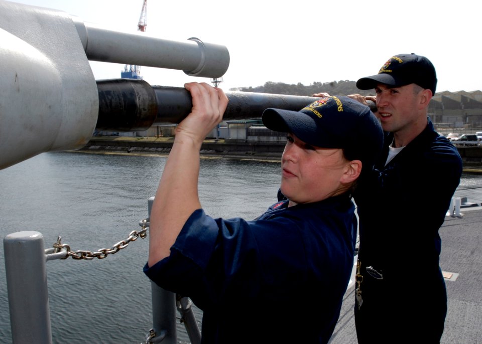 US Navy 090317-N-9520G-021 Gunner's Mate 2nd Class Lenore Manaughboehm and Gunner's Mate 3rd Class Michael Hartley reinstall the barrel of a 25mm chain gun