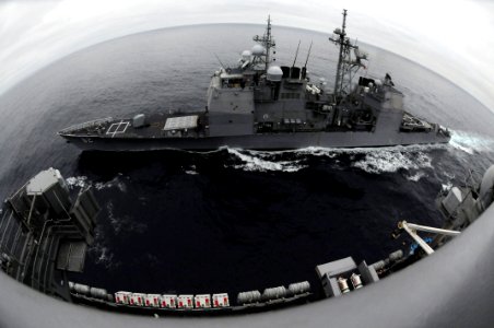 US Navy 090321-N-7730P-005 The guided-missile cruiser USS Chancellorsville (CG 62) is underway beside the aircraft carrier USS Ronald Reagan (CVN 76) before a fueling at sea