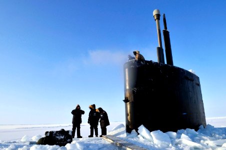 US Navy 090322-N-8273J-141 Members of the Applied Physics Laboratory Ice Station clear ice from the hatch of the Los Angeles-class submarine USS Annapolis (SSN 760) after the sub broke through the ice while participating in Ice photo