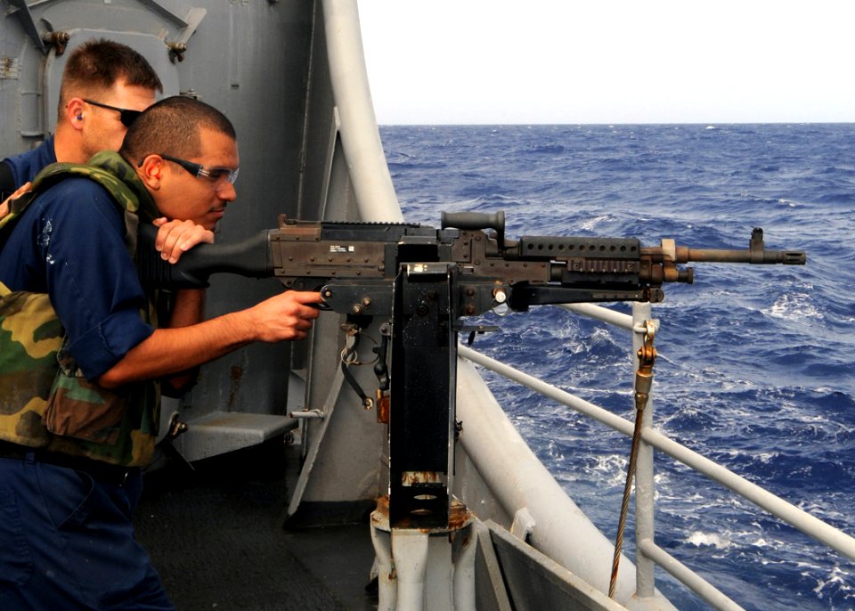 US Navy 090319-N-1082Z-021 Chief Gunner's Mate David C. Brown monitors Ship's Serviceman 3rd Class Romulo Casavilca during an M240B machine gun qualification shoot aboard the guided-missile cruiser USS Vella Gulf (CG 72)