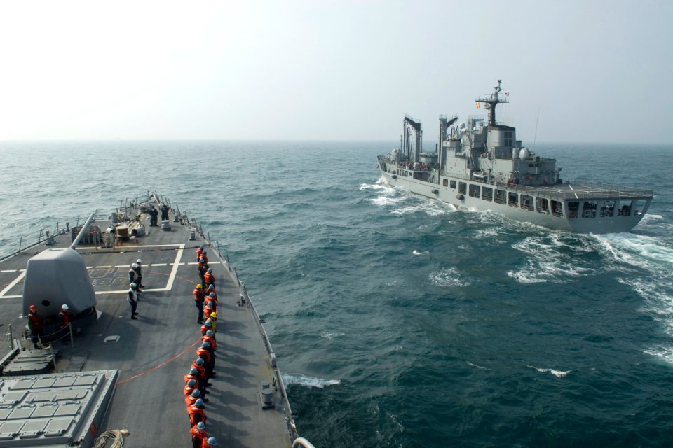US Navy 090318-N-9123L-001 Line handlers aboard the guided-missile destroyer USS John S. McCain (DDG 56) stand by as the ship approaches the Republic of Korea oiler ROKS Hwachon (AOE 59) for an underway replenishment