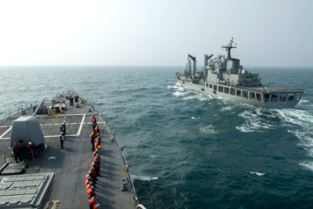 US Navy 090318-N-9123L-001 Line handlers aboard the guided-missile destroyer USS John S. McCain (DDG 56) stand by as the ship approaches the Republic of Korea oiler ROKS Hwachon (AOE 59) for an underway replenishment