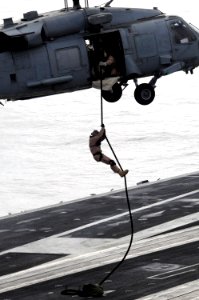US Navy 090319-N-3610L-440 A member of Explosive Ordnance Disposal (EOD) Unit 11 rapels from an HH-60H Sea Hawk hleicopter photo