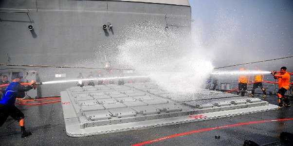 US Navy 090319-N-4774B-019 Members of firefighting teams aboard the guided-missile cruiser USS Lake Champlain (CG 57) aim water hoses at a target during a training exercise