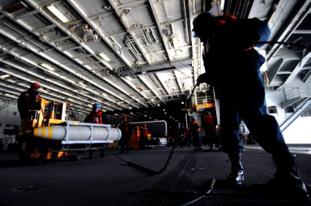 US Navy 090321-N-7364R-068 Deck and weapons department secure ordnance in the hangar bay of the aircraft carrier USS Harry S. Truman (CVN 75)