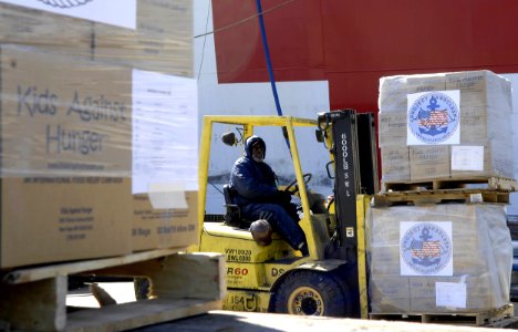 US Navy 090324-F-7923S-014 Crews load 175-pound pallets of medical supplies and personal hygiene items donated to Project Handclasp aboard the Military Sealift Command hospital ship USNS Comfort (T-AH 20)