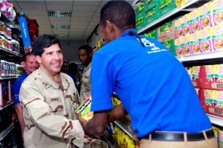 US Navy 090319-N-9552I-005 Rear Adm. Robert J. Bianchi, commander, Navy Exchange Service Command, greets a local Djiboutian Navy Exchange employee at the Navy Exchange at Camp Lemonier