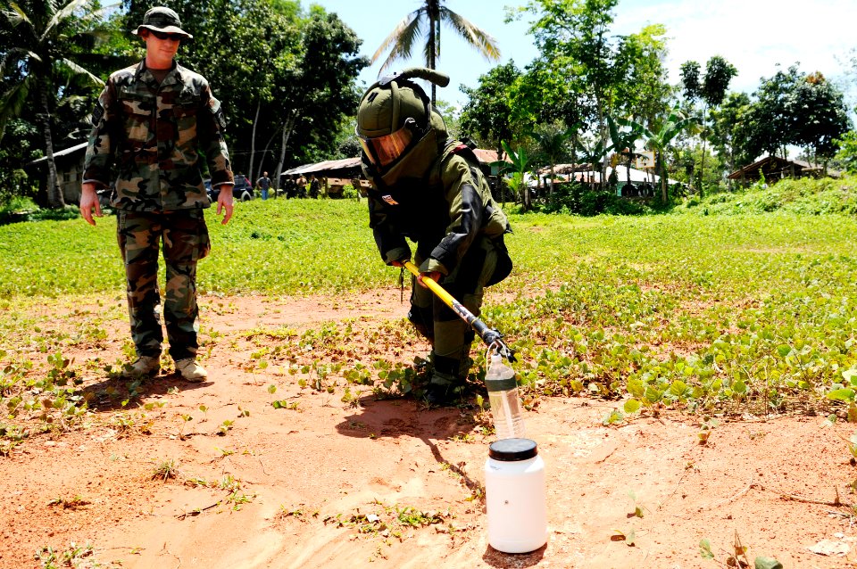US Navy 090321-N-7130B-095 Chief Explosive Ordnance Disposal Technician Kenneth Simpson watches as a member of the Armed Forces of the Philippines Army Explosive Ordnance Disposal Unit places an explosive tool