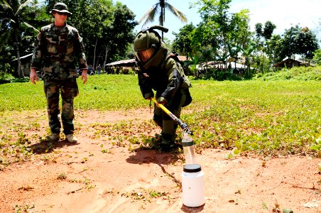 US Navy 090321-N-7130B-095 Chief Explosive Ordnance Disposal Technician Kenneth Simpson watches as a member of the Armed Forces of the Philippines Army Explosive Ordnance Disposal Unit places an explosive tool photo