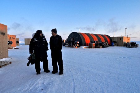 US Navy 090321-N-8273J-081 Lt. Roger Callahan speaks with camp medic Lt. Huy Phun about cold weather safety gear at the Applied Physics Lab Ice Station camp in the Arctic Ocean photo