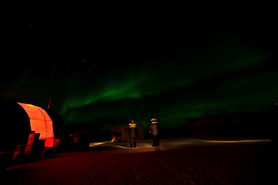 US Navy 090321-N-8273J-011 Personnel from the Applied Physics Lab Ice Station watch the aurora borealis light up the night sky over the camp in the Arctic Ocean