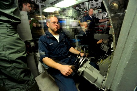 US Navy 090321-N-8273J-607 Helmsmen Sonar Technician 3rd Class Zach Howe watches a depth gage aboard the Los Angeles-class submarine USS Annapolis (SSN 760) during a stationary ascent through approximately three feet of ice in photo