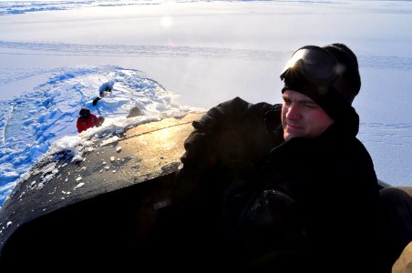 US Navy 090322-N-8273J-344 A lookout aboard the Los Angeles-class submarine USS Annapolis (SSN 760) stands watch from the bridge after breaking through three feet of ice while participating in Ice Exercise (ICEX) 2009 photo