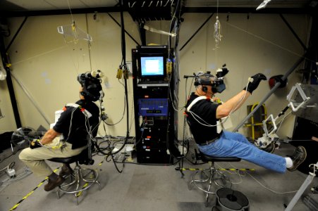 US Navy 090325-N-2959L-542 Astronauts Tom Marshburn, left, and Dave Wolf train for a spacewalk in the Integrated EVA-RMS Virtual Reality Simulator Facility at Johnson Space Center