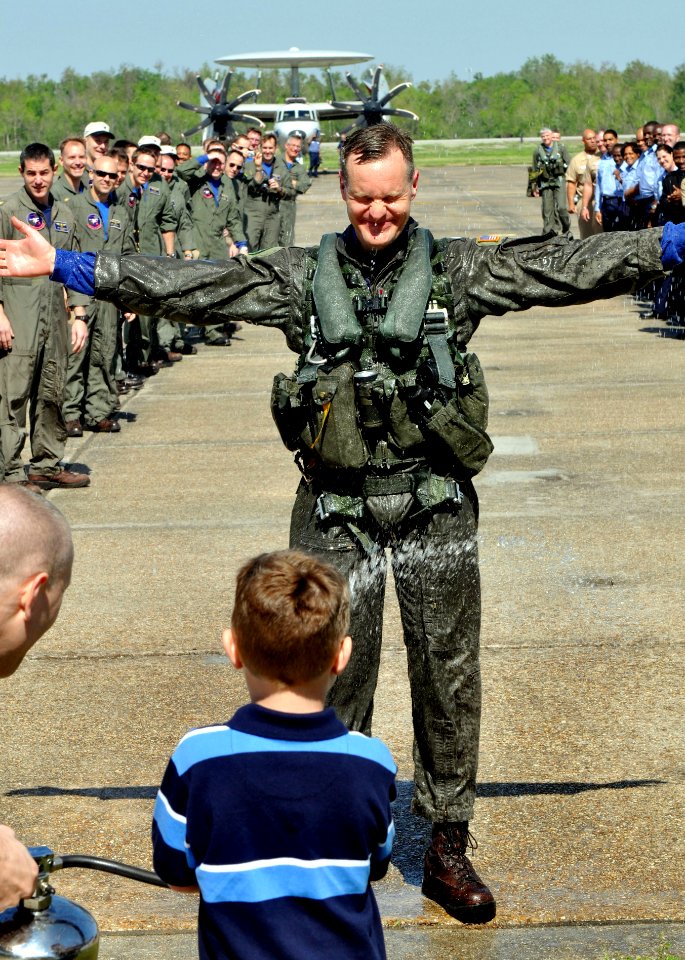 US Navy 090321-N-9712C-001 Cmdr. Steven Hartman is sprayed with water by his son after his final flight as commanding officer of Airborne Early Warning Squadron (VAW) 77