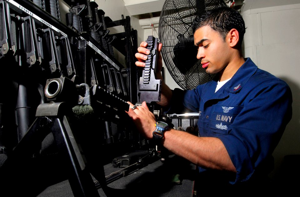US Navy 090325-N-6597H-068 Aviation Ordnanceman 3rd Class Jamie McTizic, from Hobbs, N.M., cleans an M-240 machine gun in the armory aboard the Nimitz-class aircraft carrier USS John C. Stennis (CVN 74)