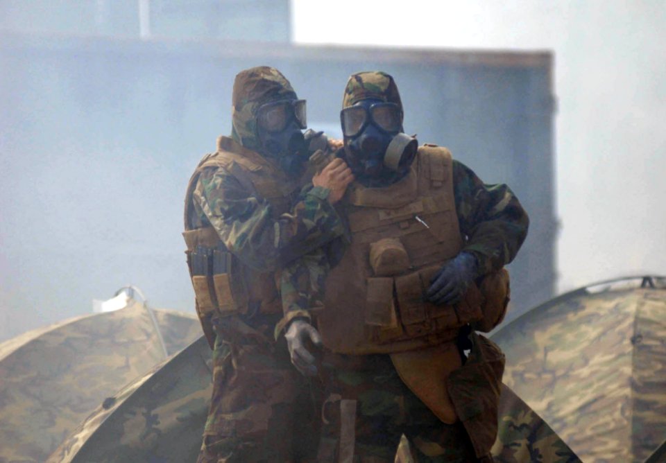 US Navy 090322-N-3674H-048 Seabees assigned to Naval Mobile Construction Battalion (NMCB) 74 don mission oriented protective posture (MOPP) gear in a cloud of CS gas during a field training exercise at Camp Shelby, Miss