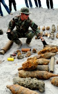 US Navy 090325-N-7130B-070 Chief Explosive Ordnance Disposal Technician Kenneth Simpson, assigned to Joint Special Operations Task Force-Philippines Explosive Ordnance Disposal Task Unit, inspects ordnance before a scheduled or photo