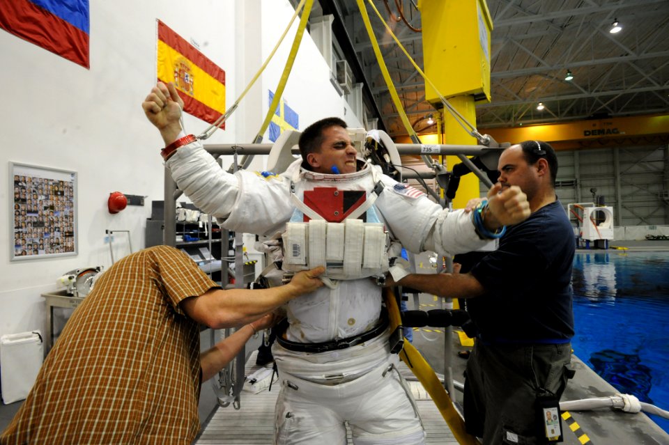 US Navy 090324-N-2959L-143 Lt. Cmdr. Chris Cassidy receives help donning his space suit before a training session at the Neutral Buoyancy Laboratory (NLB) in Houston photo