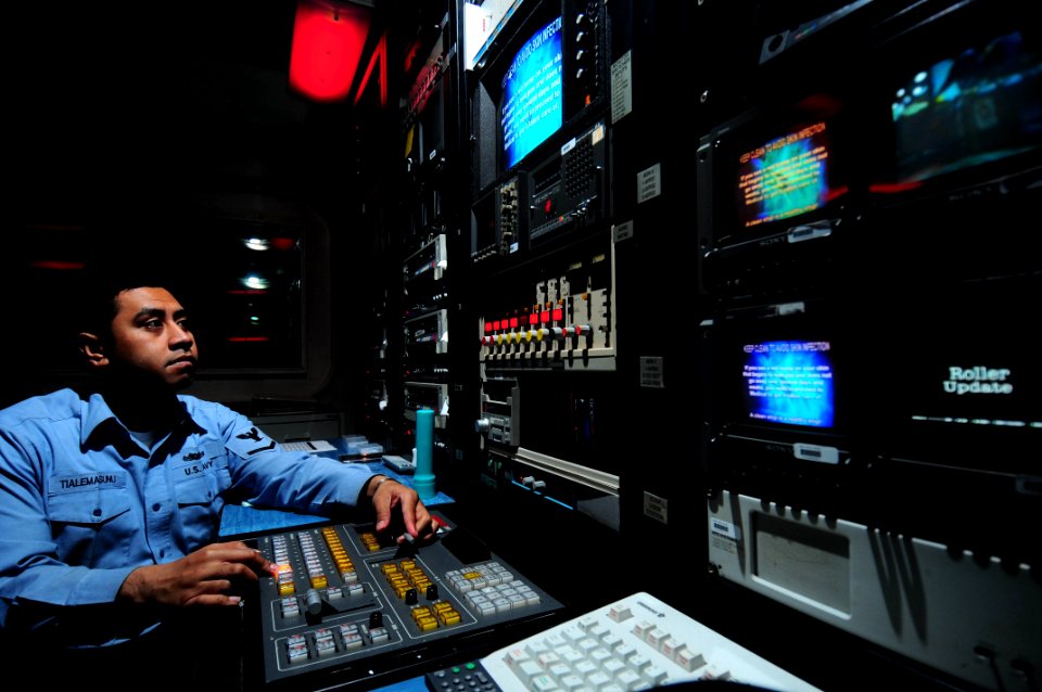US Navy 090324-N-3946H-008 Mass Communication Specialist 3rd Class Michael Tialemasunu performs a daily operational check on the Integrated Training and Entertainment Television (SITE TV) system aboard the nuclear-powered aircr