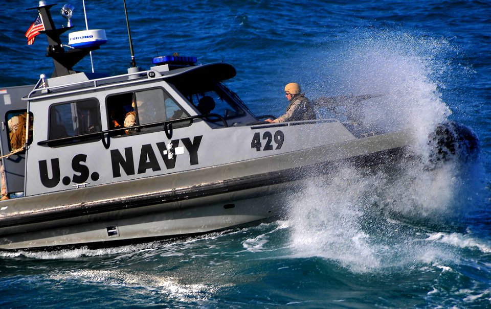 US Navy 090326-N-4774B-059 A Navy patrol boat assigned to Inshore Boat Unit (IBU) 22 approaches the guided-missile cruiser USS Lake Champlain (CG 57) as it patrols the waters surrounding the Al Basra Oil Terminal off the coast