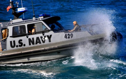 US Navy 090326-N-4774B-059 A Navy patrol boat assigned to Inshore Boat Unit (IBU) 22 approaches the guided-missile cruiser USS Lake Champlain (CG 57) as it patrols the waters surrounding the Al Basra Oil Terminal off the coast