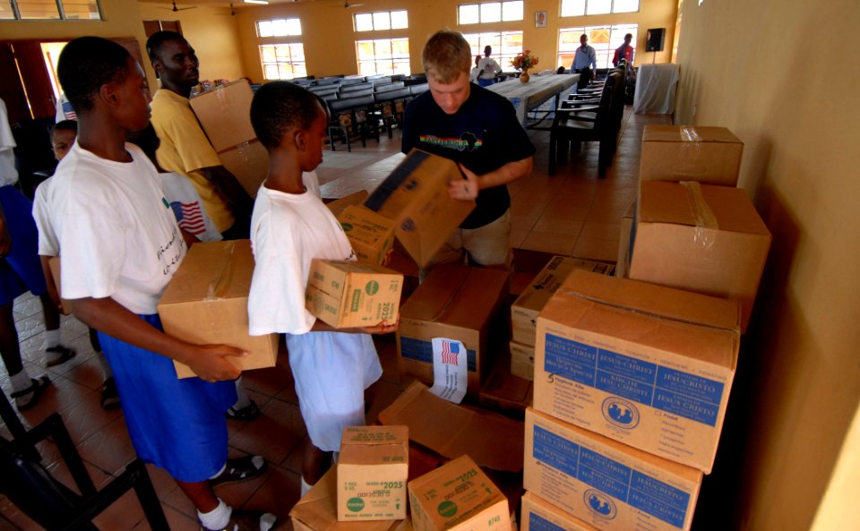 US Navy 090324-N-1688B-010 Students from Pacelli School of the Blind in Lagos Nigeria help Operations Specialist Seaman Reilly Mealer stack Operation Handclasp donations