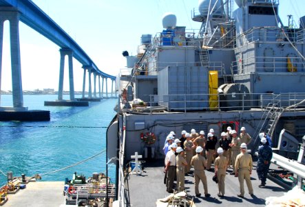 US Navy 090324-N-5617R-036 Service members and non-governmental organization personnel cross the brow to start a tour and familiarize themselves to the ship spaces aboard the amphibious transport dock ship USS Dubuque (LPD 8)
