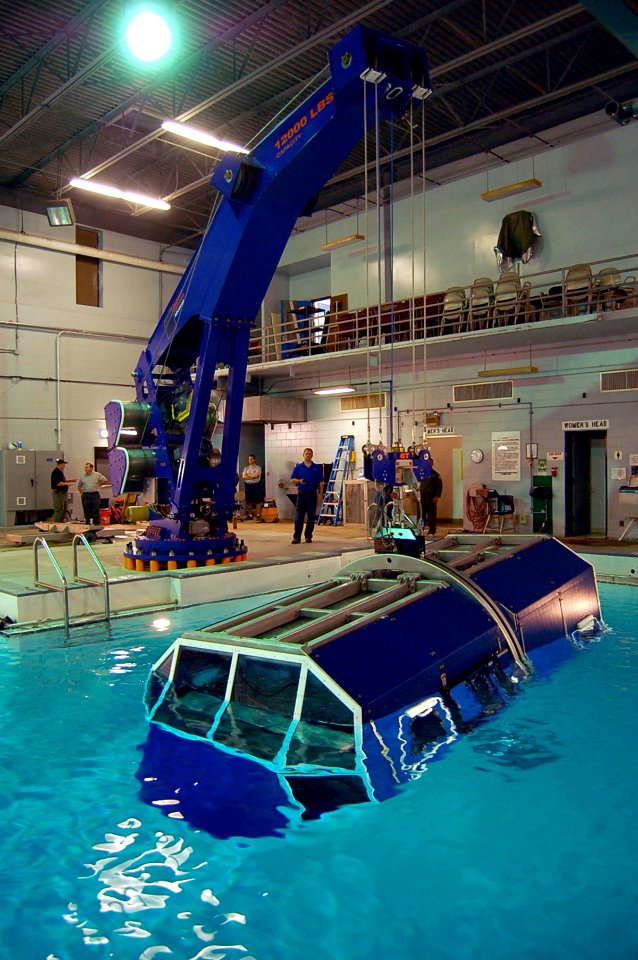 US Navy 090325-N-6720T-002 Civilian technician Sean Glase uses a hand-held remote control to lower the new 9D6 underwater egress trainer during a test at Aviation Survival Training Center Jacksonville