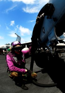 US Navy 090325-N-9928E-128 Aviation Boatswain's Mate (Fuels) Airman Travis Hinde from Des Plaines, Ill., refuels an F-A-18C Hornet from the