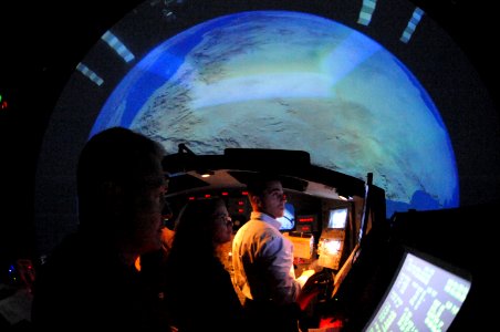 US Navy 090325-N-2959L-844 Lt. Cmdr. Chris Cassidy, center, practices docking the space shuttle with his shuttle commander and pilot in a virtual reality simulator at Johnson Space Center photo