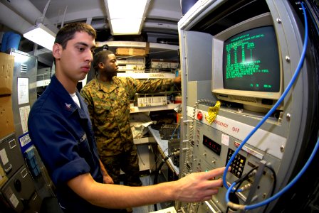 US Navy 090326-N-2475A-038 Aviation Electronics Technician 3rd Class John Blackwood, left, from San Angelo, Texas, sends signals to a data link radio