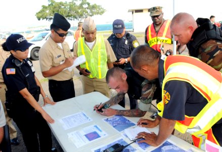 US Navy 090325-N-3666S-107 Personnel assigned to Naval Station Pearl Harbor review a map of the affected area during a chemical, biological, radiological, nuclear and explosive exercise on historic Ford Island