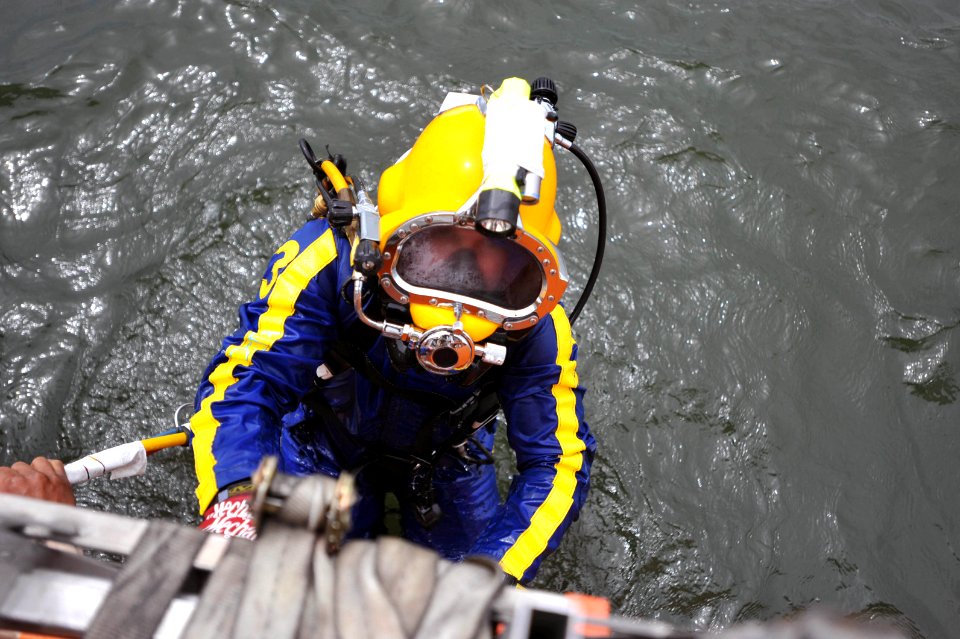 US Navy 090329-N-5242D-128 Master Chief Navy Diver Arne Phillips, a master diver assigned to Mobile Diving and Salvage Unit 2, climbs out of Africa's Lake Victoria after completing a dive